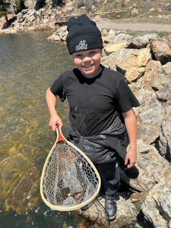 AXL 8th grade student showing a salamnder in a net that he found on the overnight trip